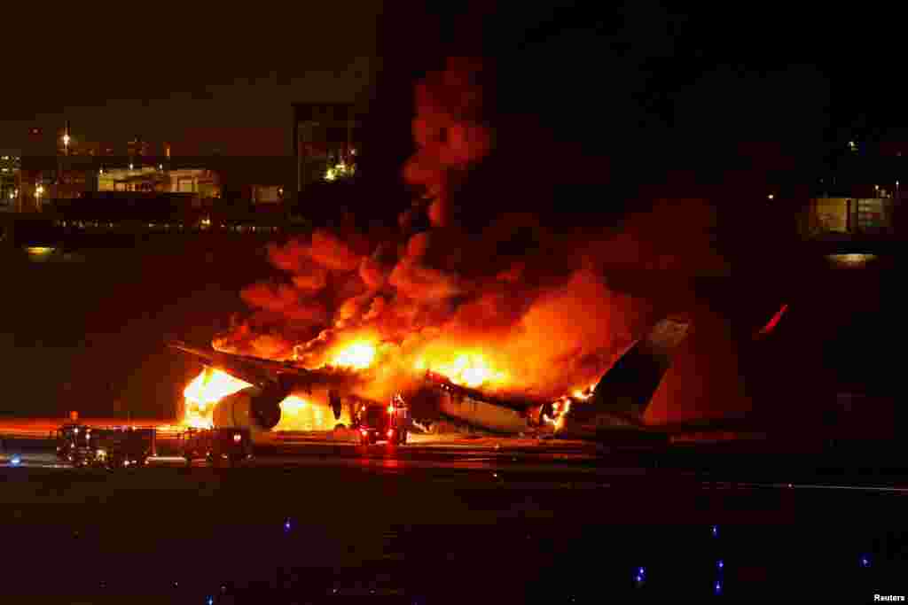 Japan Airlines&#39; A350 airplane is on fire at Haneda international airport in Tokyo.&nbsp;All 379 people aboard the plane escaped the burning airliner after a collision with a Coast Guard aircraft at the airport that killed five of six crew on the smaller craft.