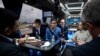 Britain's Prime Minister and Conservative Party leader, Rishi Sunak, center, speaks with journalists aboard the party campaign bus on its way to Grimsby, England, June 12, 2024, ahead of the UK General Election on July 4. 