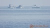 Chinese Coast Guard boats close to the floating barrier are pictured on Sept. 20, 2023, near the Scarborough Shoal in the South China Sea, in this handout image released by the Philippine Coast Guard on Sept. 24, 2023. (Handout via Reuters)
