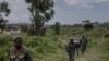 Waasi wa kundi la M23 wakilinda eneo hilo wakati wa mkutano kati ya maafisa wa Kikosi cha Afrika Mashariki (EACRF) na waasi wa M23 katika kambi ya Rumangabo huko DRC Januari 6, 2023. Picha na Guerchom Ndebo/AFP