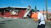 A man walks past a damaged supermarket in Noumea, France's Pacific territory of New Caledonia, on May 24, 2024. 