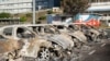 Burnt-out cars are seen in the parking lot of the old hospital on the outskirts of Noumea, French territory of New Caledonia, May 16, 2024. 