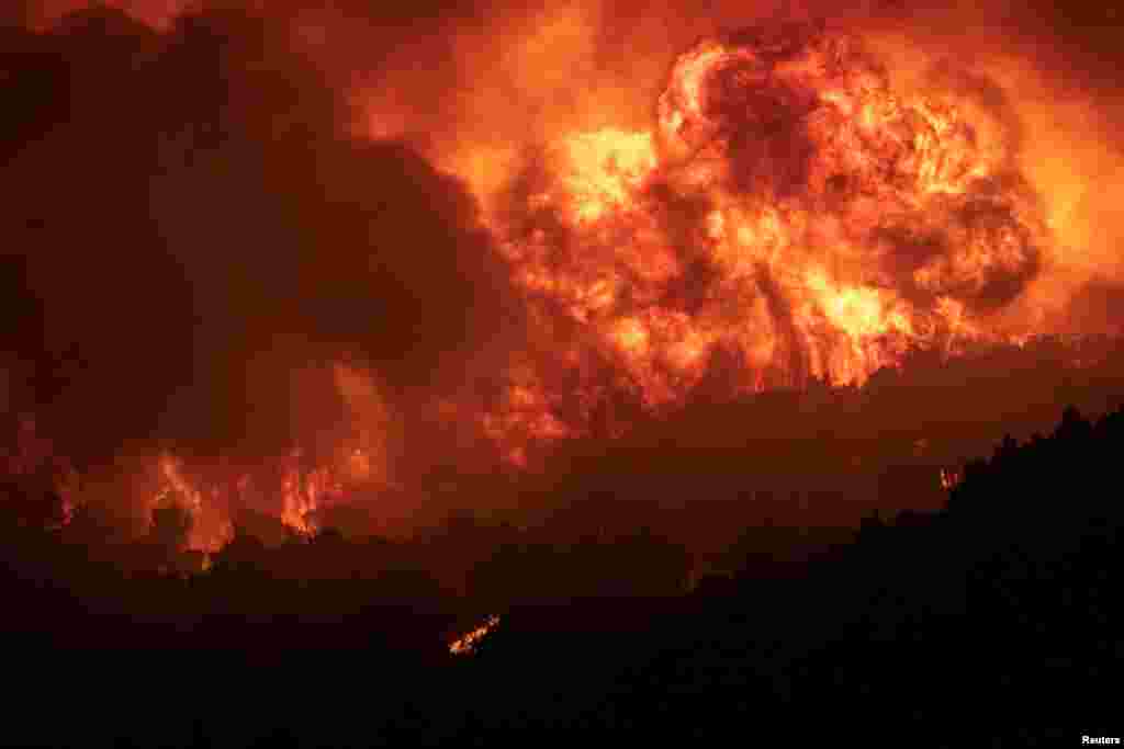 Flames rise as a wildfire burns on Mount Parnitha, in Athens, Greece.