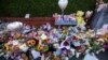 FILE - Flowers and toys are placed on the junction of Tithebarn Road and Hart Street in Southport, England, July 31, 2024, after three girls were killed in a knife attack at a Taylor Swift-themed holiday club earlier in the week. 