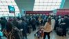 FILE - Passengers queue at a flight connection desk at the Dubai International Airport in Dubai, United Arab Emirates, April 17, 2024. 