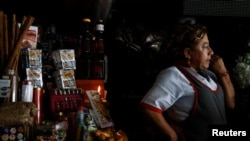 FILE - A saleswoman waits for customers at her stand during a power cut, in Quito, Ecuador, April 18, 2024. The entire country lost power on June 19, 2024, for periods of time due to production problems.
