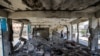 Boys walk past a destroyed classroom where people were sheltering at a school run by the U.N. Relief and Works Agency for Palestine Refugees that was previously hit by Israeli bombardment, in the Nuseirat camp in the Gaza Strip on June 7, 2024.