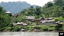 FILE - An Awajun village is seen along the Maranon River in Amazonas state, Peru, Aug. 12, 2009. More than 500 cases of sex abuse dating as far back as 2010 have been reported by Awajun youths who attended public schools in Peru's north.