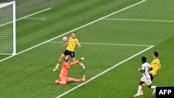Real Madrid's Vinicius Junior scores his team's second goal past Dortmund's Swiss goalkeeper Gregor Kobel during the UEFA Champions League final football match between Borussia Dortmund and Real Madrid, in London, on June 1, 2024.