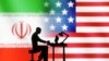 Figurines with computers are seen in front of USA and Iran flags in this illustration made on Sept. 10, 2022.