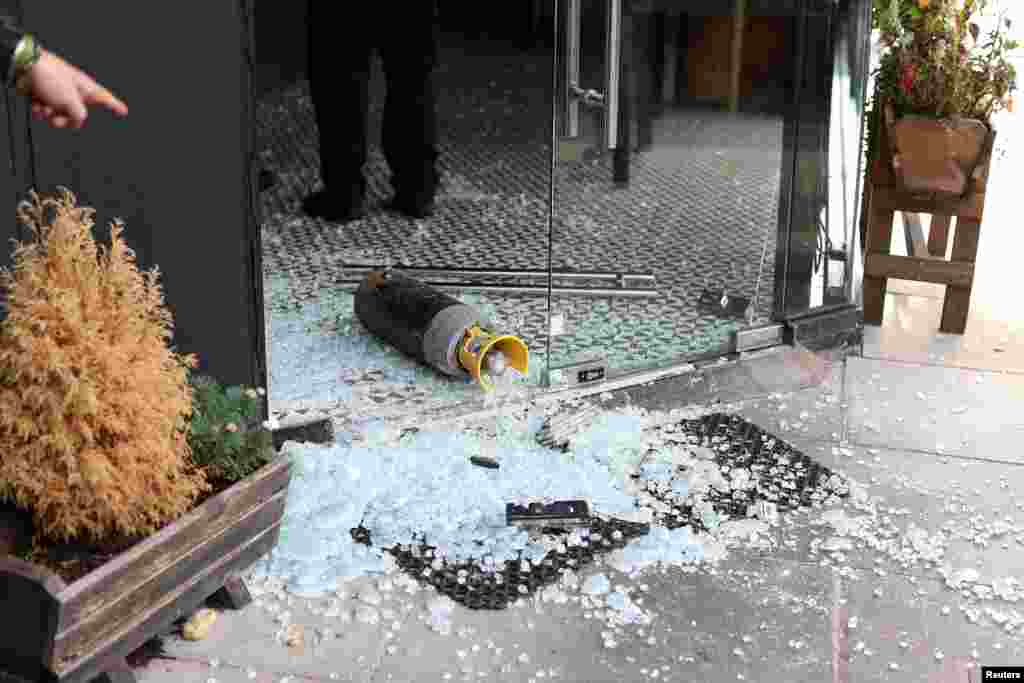 A vandalized Kosher restaurant is seen near a bridge with 'Free Palestine' painted on it, in Golders Green in London.
