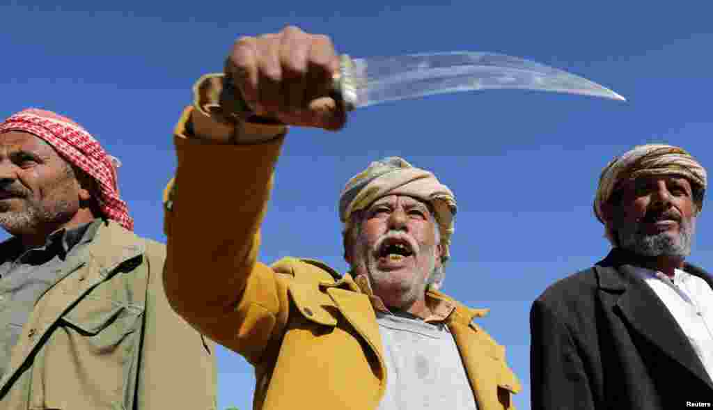 A tribal supporter of Yemen&#39;s Houthis hold his traditional dagger, or jambiya, during a protest against recent U.S.-led strikes on Houthi targets, near Sanaa.