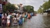 Residents wade through a flooded street as they evacuate their homes in Chennai, in the southern state of Tamil Nadu, India, Dec. 3, 2015. 