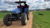 A farmer drives a tractor through a wheat farm in the Banket Zvimba district in Zimbabwe on May 4, 2022.