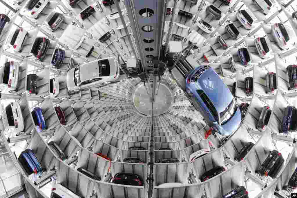 Volkswagen cars are presented to media inside a delivery tower prior to the company's annual press conference in Wolfsburg, Germany.