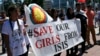 FILE - Women hold a banner during a demonstration marking the first anniversary of Islamic State's surge on Yazidis of the town of Sinjar, in front of the United Nations European headquarters in Geneva, Switzerland, August 3, 2015.