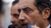Fawaz al-Etan, the Jordanian ambassador in Libya, speaks to the press upon his arrival to Marka Military Airport, in Amman, Jordan, Tuesday, May 13, 2014