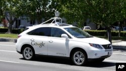 FILE - A Google self-driving car goes on a test drive near the Computer History Museum in Mountain View, Calif, May 14, 2014. 
