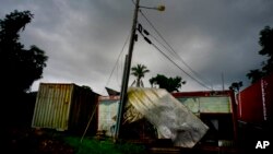 A Coca-Cola trailer destroyed one year ago by Hurricane Maria stands on the side of the road in Orocovis, Puerto Rico, Sept. 7, 2018. 