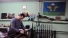 FILE - A member of the Russian Imperial Movement, a nationalist group in Russia, Denis Valliullovich Gariev holds a weapon simulator at a training base in Saint-Petersburg, Feb. 28, 2015.