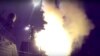 A Russian navy ship launches a cruise missile in the Caspian Sea in this photo made from video footage taken from Russian Defense Ministry official web site, Oct. 7, 2015.