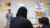 FILE - Afghan refugees take a class at the Fort McCoy, Wis., U.S. Army base, Sept. 30, 2021. The fort is one of eight military installations across the country that are temporarily housing tens of thousands of Afghan refugees. 