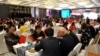FILE - Local businessmen and foreign investors negotiate at a cross-border investment and trade fair in Guiyang, Guizhou Province, China, Nov. 10, 2016. 