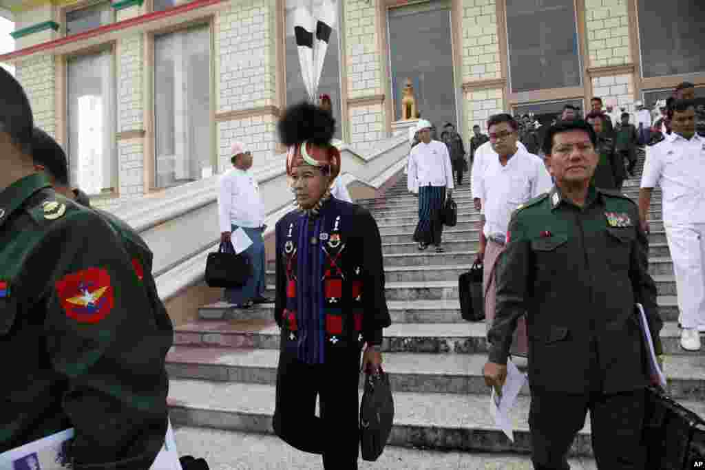 Military representatives and lawmakers arrive to attend a regular session of the lower house of Parliament, Tuesday, Aug. 18, 2015, in Naypyitaw, Myanmar. Myanmar's parliament reopened Tuesday for its final session before November's national elections, with the spotlight on the influential speaker — who was violently ousted just days ago as head of the military-backed ruling party. (AP Photo/Khin Maung Win)