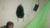 A lady in Malawi is seen spreading a mosquito net. Statistics show that only 55% of Malawians use mosquito nets to protect against Malaria. (Lameck Masina/VOA)