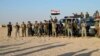 Sunni volunteer fighters are deployed to support Iraqi security forces in liberating the city from Islamic State group militants, in the eastern suburbs of Ramadi, the capital of Iraq's Anbar province, 115 kilometers west of Baghdad, Oct. 1, 2015.