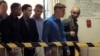 U.S. Marine Pfc. Joseph Scott Pemberton, third left, the suspect in the killing of Filipino transgender Jennifer Laude, is escorted into the courtroom for his scheduled trial, March 23, 2015, at Olongapo city, Zambales province, northwest of Manila, Philippines.
