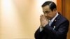 Thai Army chief General Prayuth Chan-ocha gestures in a traditional greeting during the start of a National Legislative Assembly meeting to consider urgent matters including the 2015 Budget Bill, at the parliament in Bangkok, August 18, 2014.