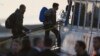Migrants get on a ferry at the port of Mytilini in the Greek island of Lesbos, April 3, 2016.