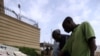 Pedestrians look at newspapers in Abuja, Nigeria on June 5, 2021.