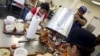 FILE - Mexican workers, on the U.S. H2B visa program for seasonal guest workers, process crabs at the A.E. Phillips & Son Inc. crab picking house on Hooper's Island in Fishing Creek, Maryland, Aug. 26, 2015.