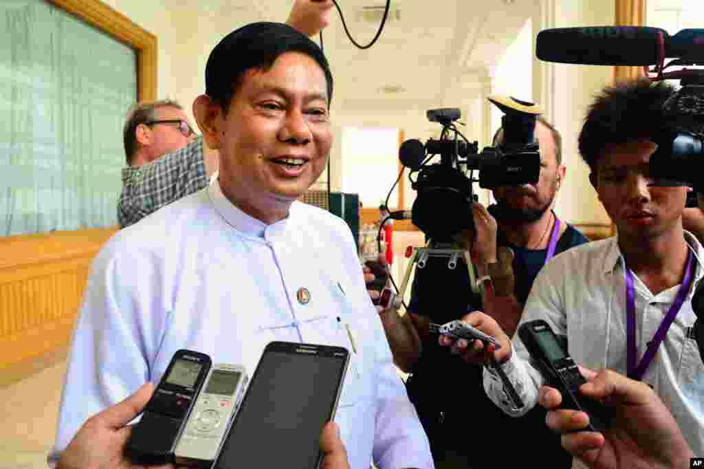 Htay Oo, left, chairman of Union Solidarity and Development Party (USDP), speaks to the media ahead of a regular session at Parliament in Naypyitaw, Myanmar Tuesday, Aug. 18, 2015. Parliament has reopened for its final session before Myanmar's nationwide election, with a spotlight on the influential speaker following his violent ouster as head of the military-backed ruling party. (AP Photo/Khin Maung Win)