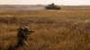 FILE - A serviceman of the Ukrainian Armed Forces takes part in military drills at a training ground near the border with Russian-annexed Crimea in Kherson region, Ukraine, in this handout picture released by Ukraine's military.
