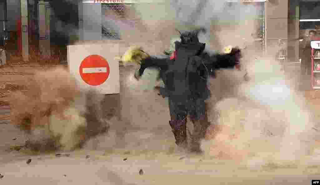 This still image grab taken from a video on Jan. 6, 2015 by the Al-Youm al-Saabi newspaper, shows an Egyptian police officer being blown up as he was trying to defuse a bomb outside a petrol station in Cairo. The officer was killed and jihadists claimed responsibility, police said. Three employees were also wounded when the device, hidden in a flower pot, exploded near a police station on Al-Harram street.
