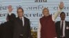 French President Francois Hollande, left, and Indian Prime Minister Narendra Modi wave at the audience as they arrive for the foundation stone laying for the headquarters of the International Solar Allliance at Gurgaon, outskirts of New Delhi, Jan. 25, 2016.
