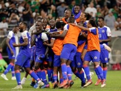 Haiti celebrates a 3-2 win over Canada in a CONCACAF Gold Cup soccer quarterfinal, June 29, 2019, in Houston.