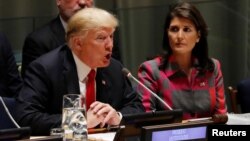 U.S. President Donald Trump speaks as U.N. Ambassador Nikki Haley looks on at the United Nations Global Call to Action on the World Drug Problem during the 73rd U.N. General Assembly in New York, Sept. 24, 2018. 