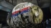 FILE - The reconstructed wreckage of the MH17 airplane is seen after the presentation of the final report on the crash in July 2014 of Malaysia Airlines flight MH17 over Ukraine, in Gilze Rijen, the Netherlands, Oct. 13, 2015. 