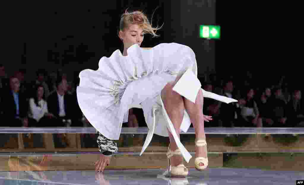 A model slips on the runway while parading an outfit by Australian designer Toni Maticevski at Fashion Week Australia in Sydney.