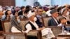 Afghan President Ashraf Ghani, center left, wears a protective face mask to help curb the spread of the coronavirus, on the last day of an Afghan Loya Jirga or traditional council, in Kabul, Afghanistan, Aug. 9, 2020. 