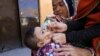 FILE - A boy receives polio vaccine drops during an anti-polio campaign in Peshawar, Pakistan, Feb. 17, 2020. 