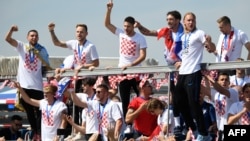 Croatian national football team members ride an open-roof coach in Zagreb International Airport on July 16, 2018 after their return from the FIFA World Cup 2018 in Russia in Zagreb International Airport.