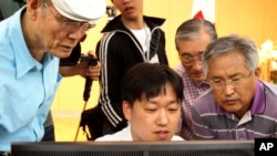 South Korean applicants check their names of candidates who were to be allowed to meet their North Korean relatives in family reunions at the headquarters of Korea Red Cross in Seoul, South Korea, Aug. 24, 2013.