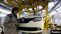 FILE - A female employee works in a Renault factory in Oran, west of Algiers.