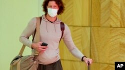 A passenger arrives early morning at Sydney Airport, Nov. 29, 2021. 