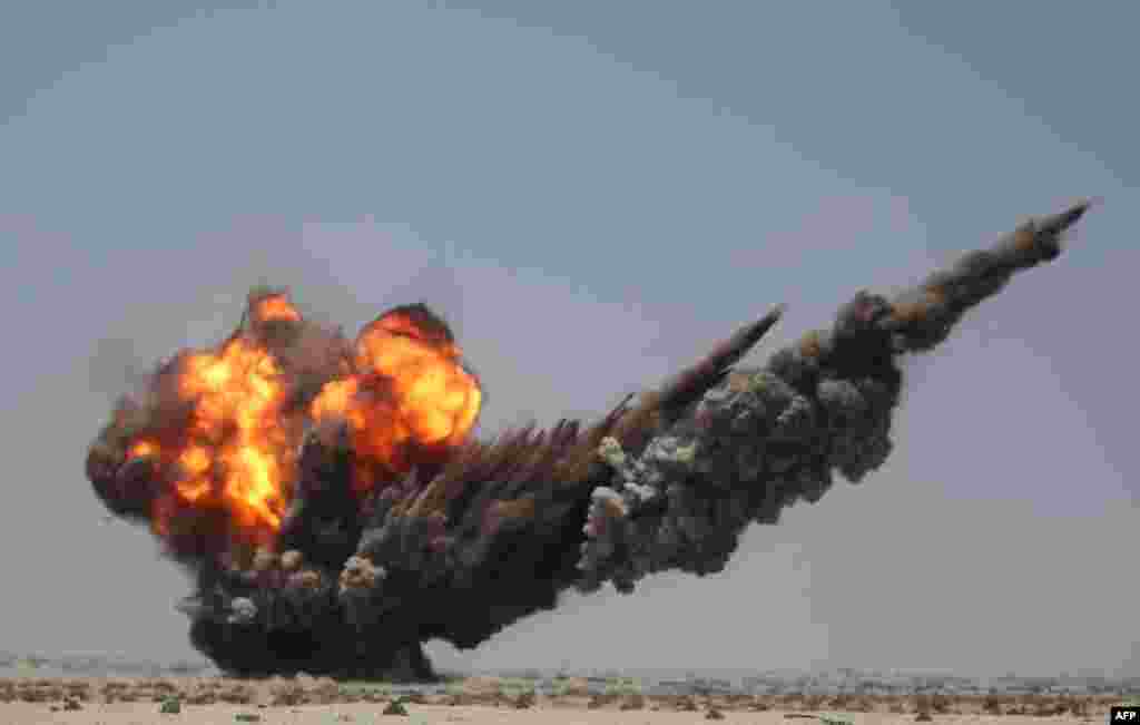 Smoke and fire billow during a controlled explosion by Yemeni experts to destroy bombs and mines laid by Houthi rebels in the southern city of Aden.